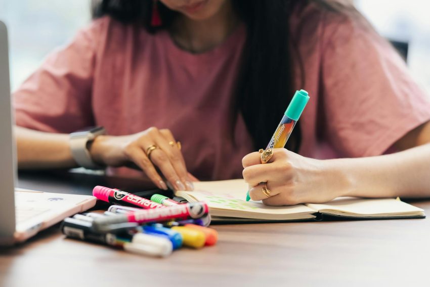 creative work with colorful markers and notebook