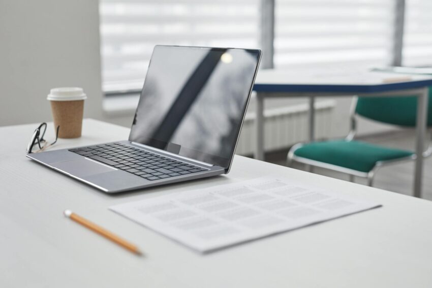 an open laptop on white table